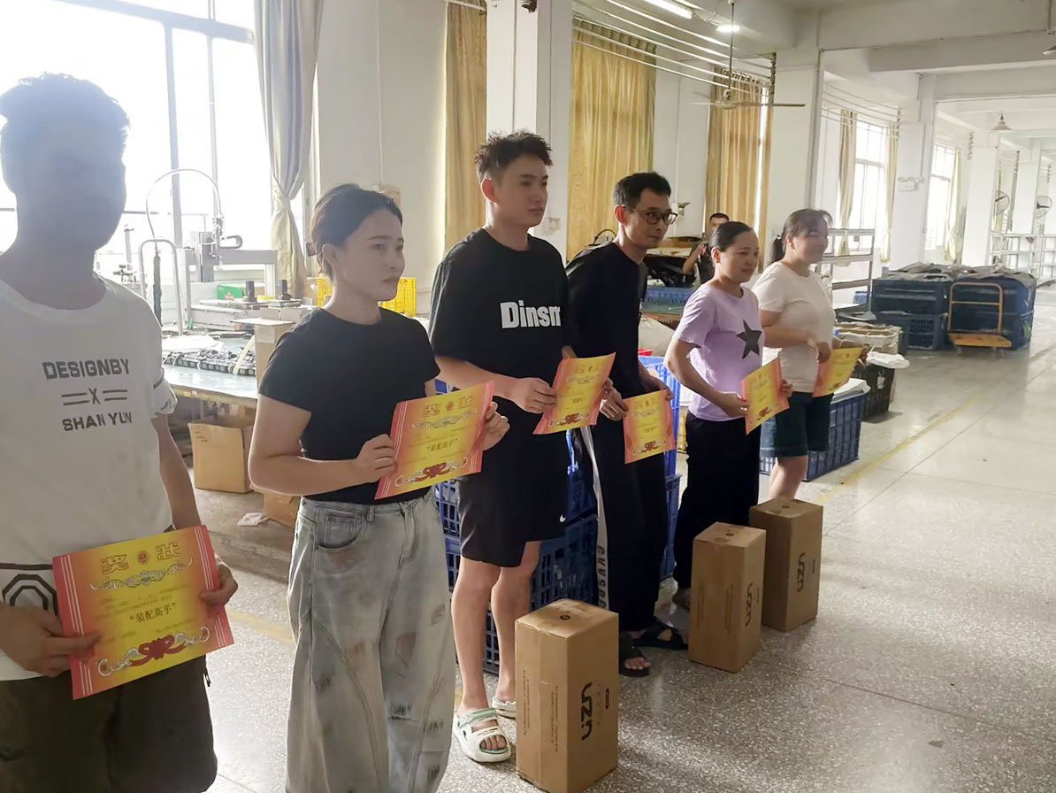 Team photo of June top assembly experts at OTESHEN LED light factory, stable production team for LED wall light & inground light